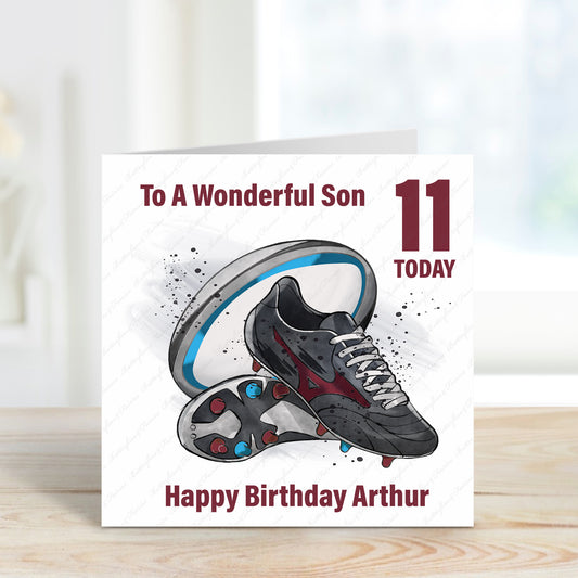 Square card with blue and burgundy rugby ball and boots