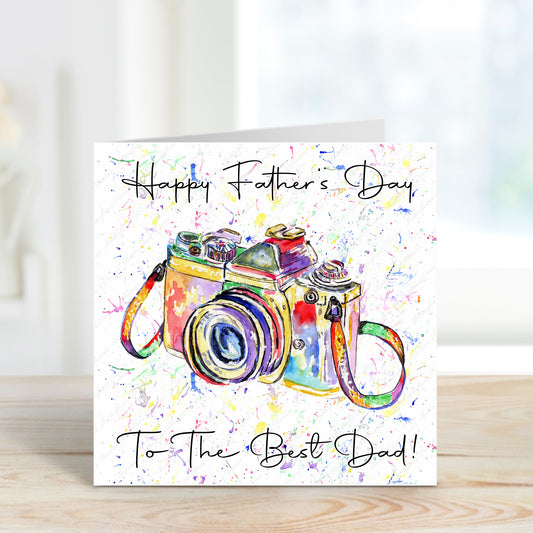 Square card with a colourful camera design with a rainbow splatter background
