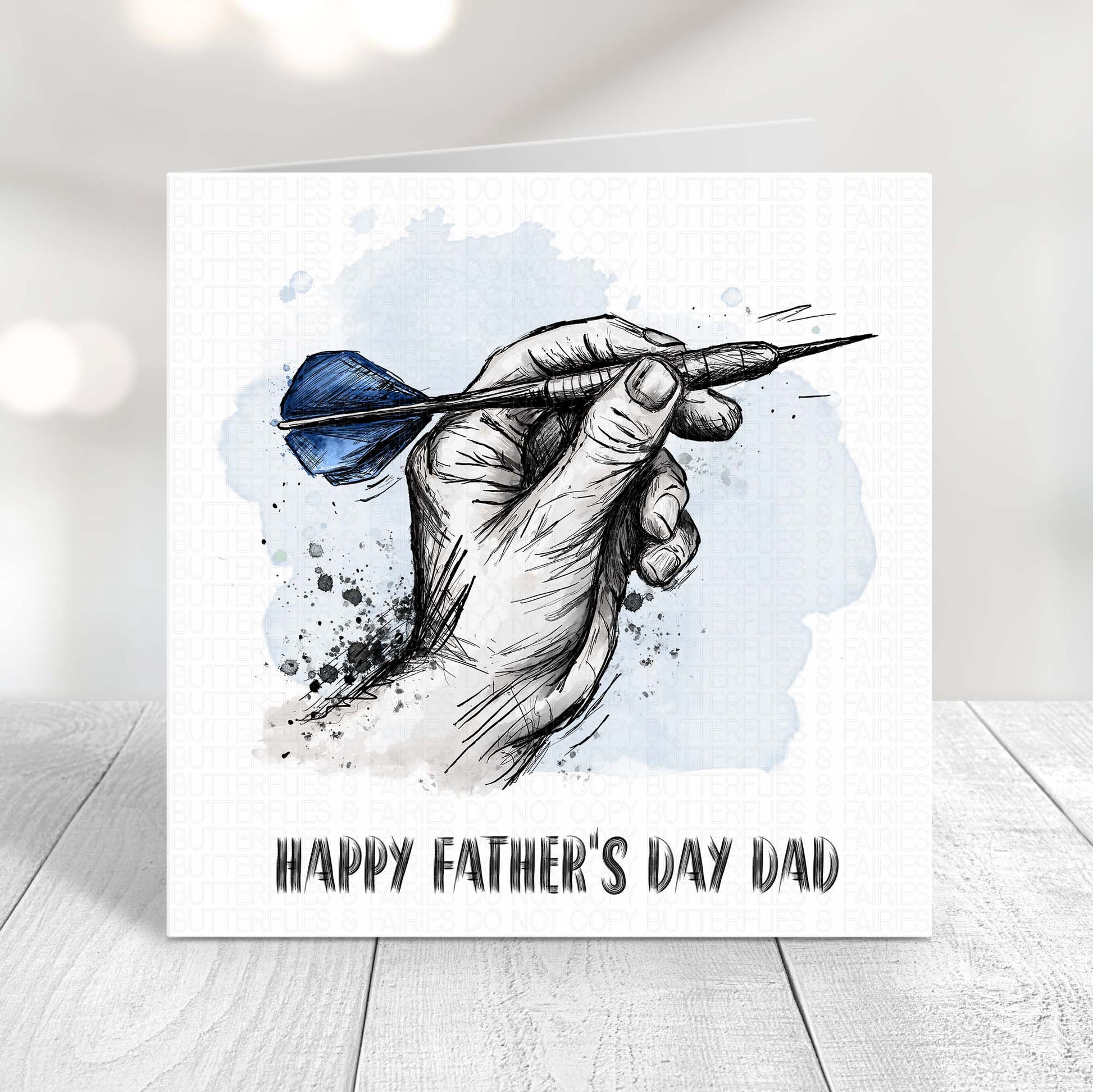 Darts Father’s Day card featuring a hand holding a dart with blue flights, perfect for dad who loves darts