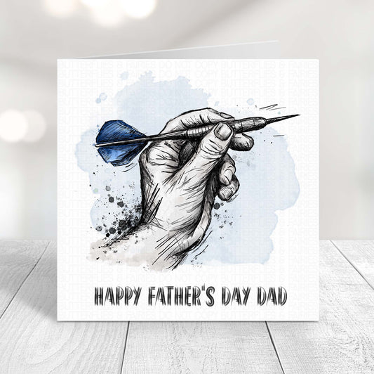 Darts Father’s Day card featuring a hand holding a dart with blue flights, perfect for dad who loves darts