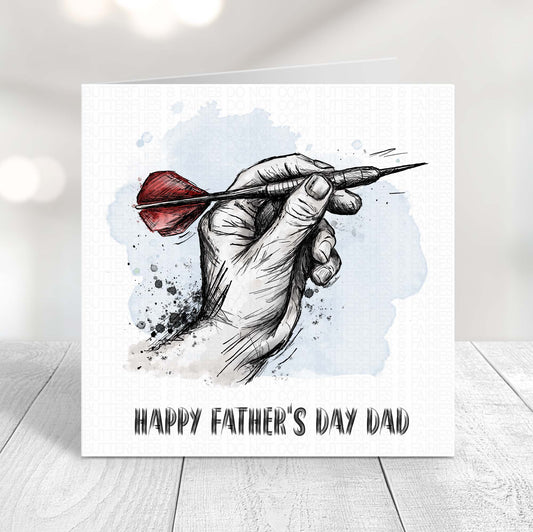 Darts Father’s Day card featuring a hand holding a dart with red flights, perfect for dad who loves darts